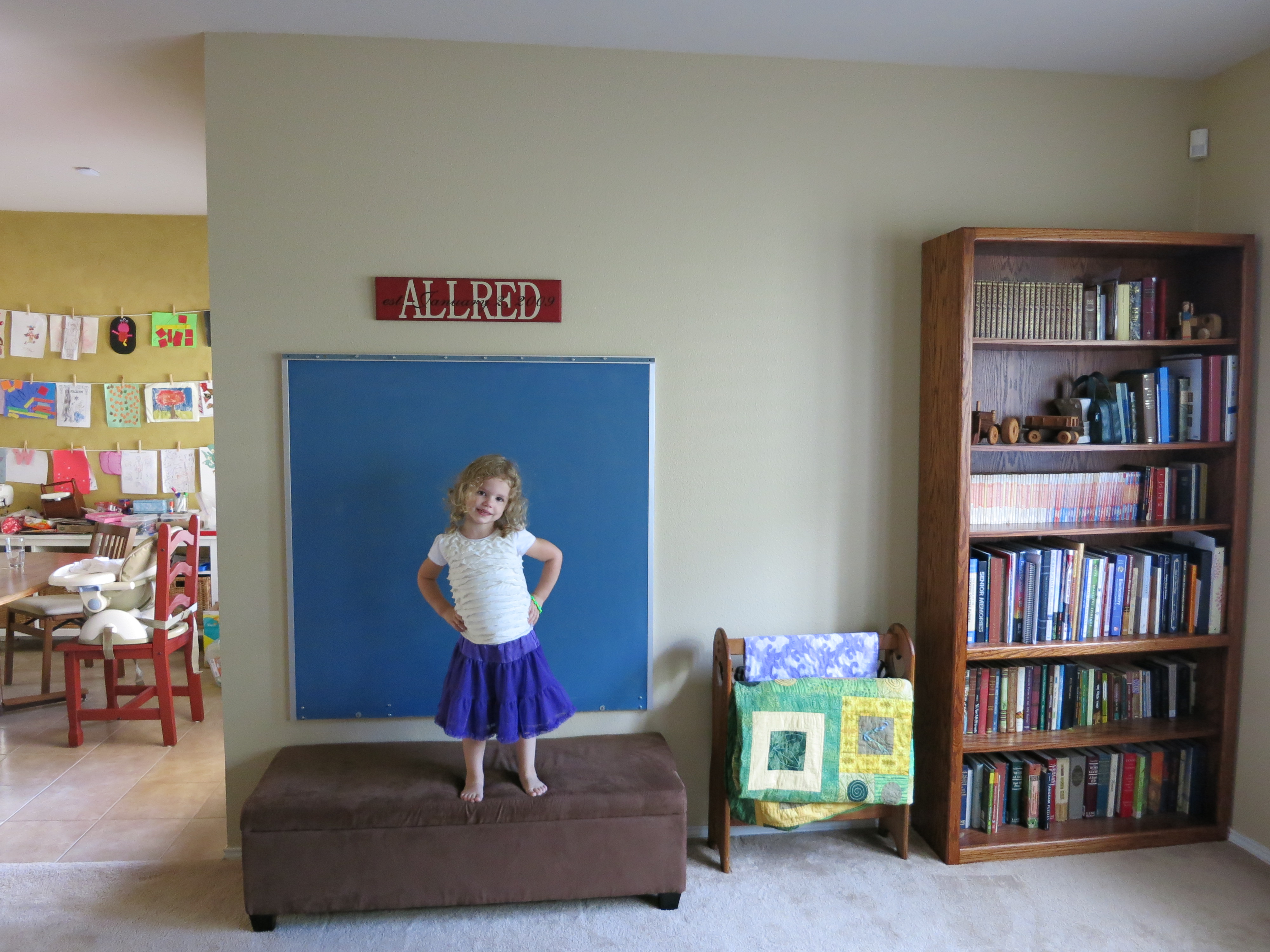 Anna in front of the chalkboard the day we hung it on the wall.